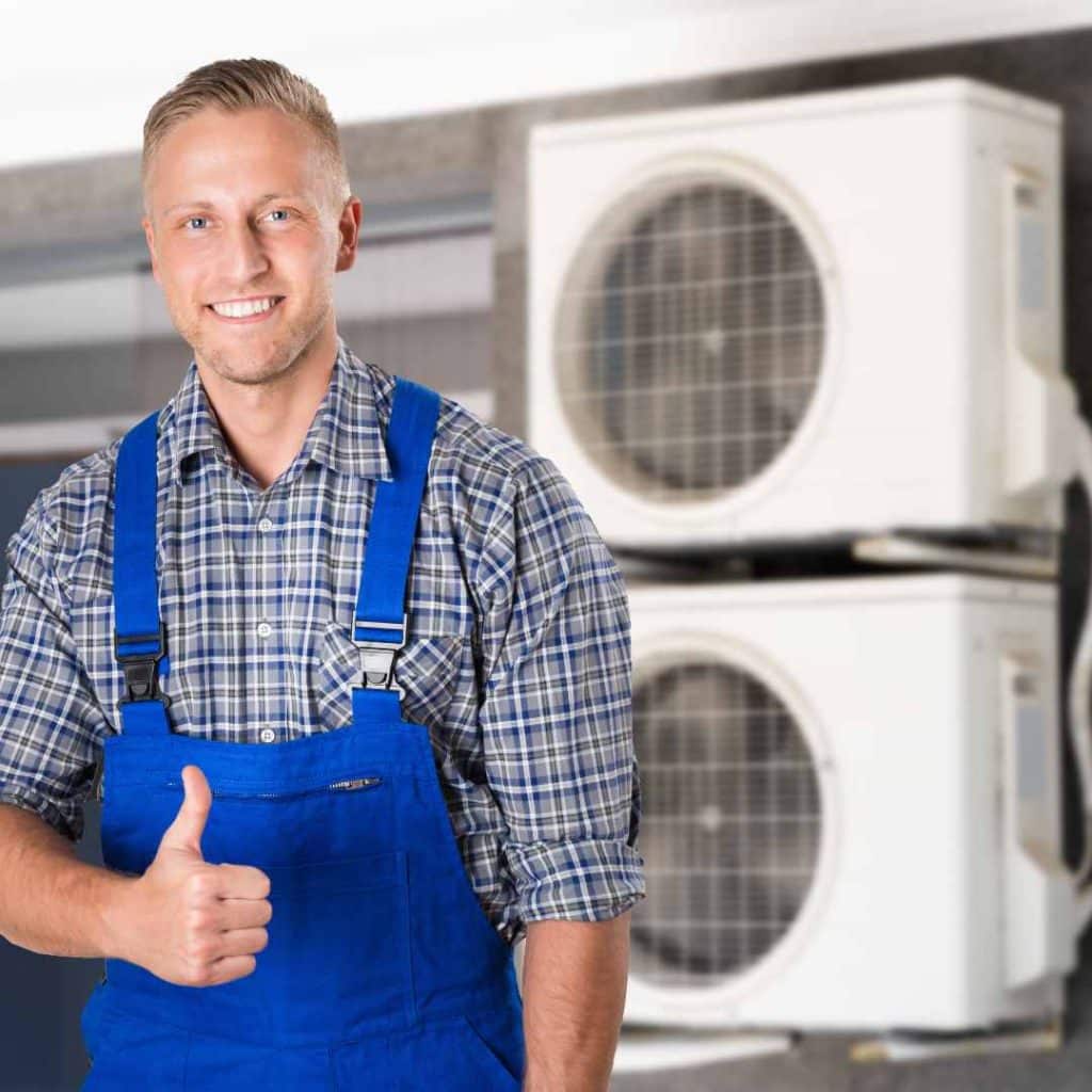 A Richard's AC & Appliance Repair technician gives a thumbs-up, symbolizing how professional maintenance extends an AC's lifespan and delays replacement costs.